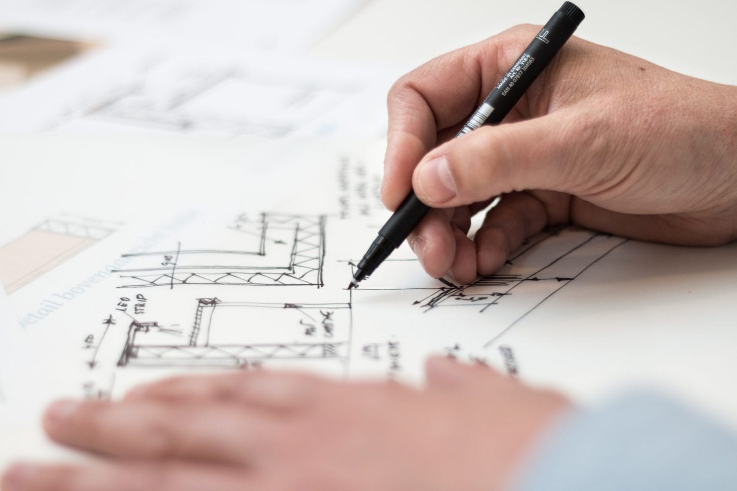 person-holding-black-pen-1109541 Kitchen design
